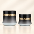 Two black and gold Xoxoderma Daily Comfort Cream jars.